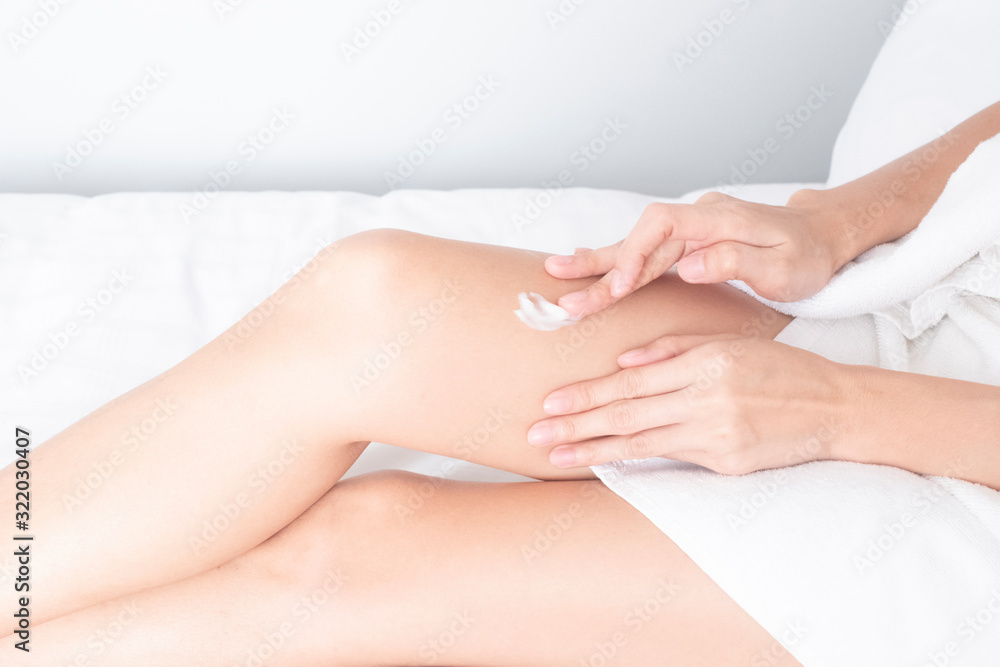 Woman applying legs cream,lotion , Hygiene skin body care concept..