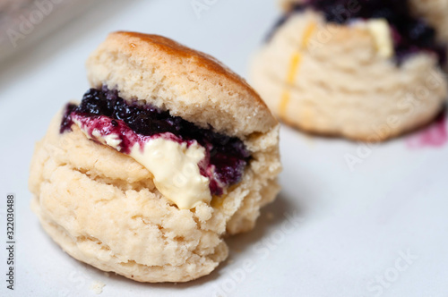 Butter scone with premium buttr and blueberry jam, tea break with butter scones.