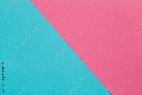 Background of two sheets of colored paper, pink and blue.