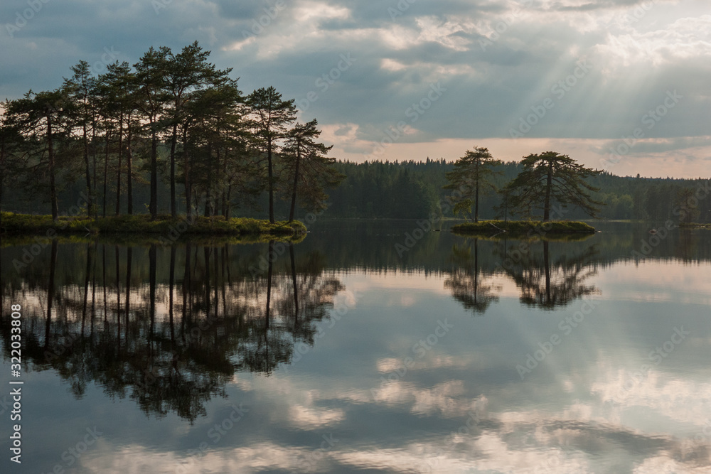 Fototapeta premium Sunrise over the lake with the reflection in the water, long shutter speed