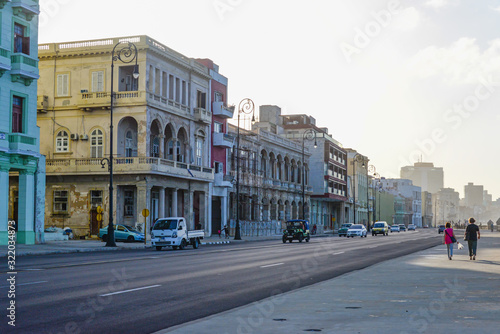 Malecon promenade with retro cars at sunset in Havana, Cuba