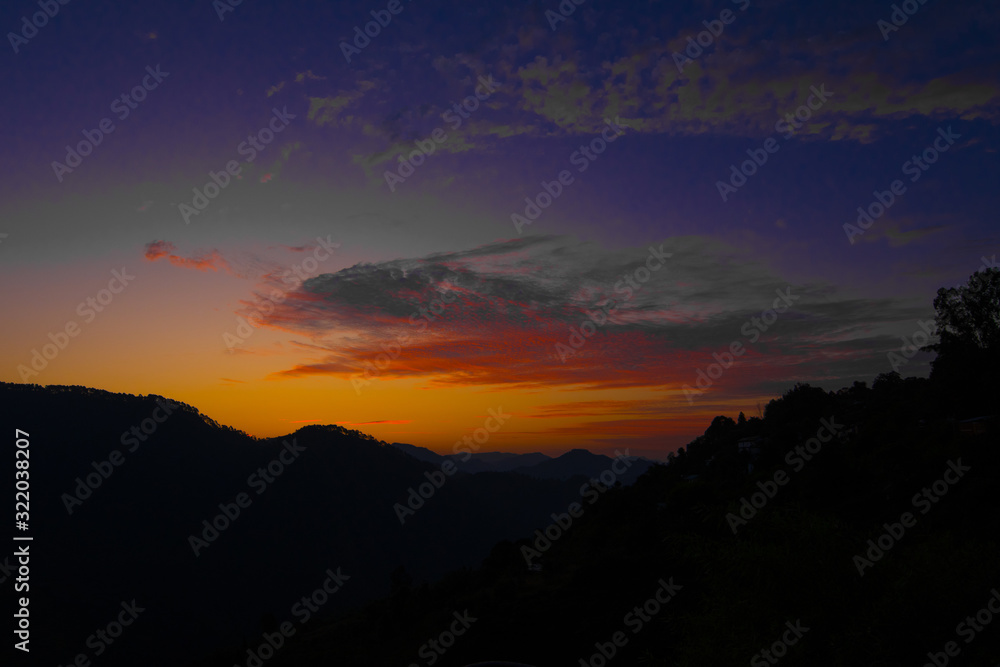 Obraz premium Beautiful Sunrise and Beautiful sunset between the mountain with orange sky, Blue sky 