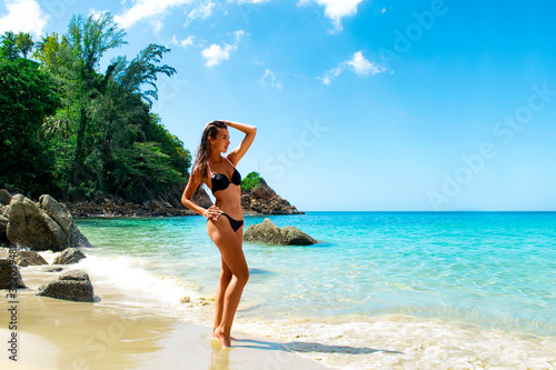 Young attractive sexy woman on the tropical beach, traveling in Phuket, Thailand. Positive emotion, summer style, smiling and happy girl. © artbox_of_life