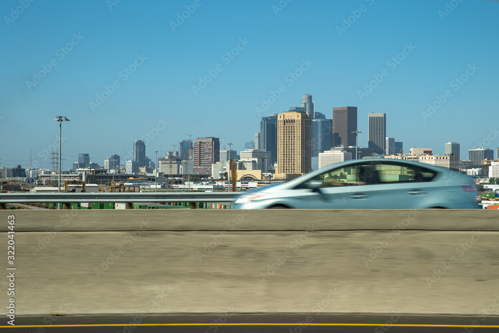 Naklejka premium Car drive through a bridge with a view of downtown Los Angeles
