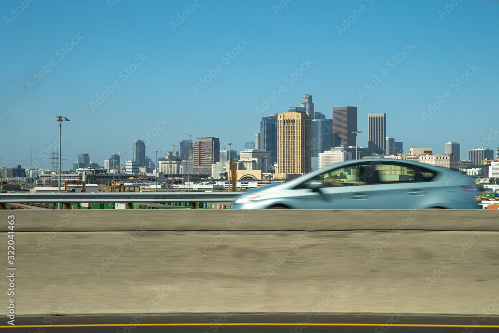 Car drive through a bridge with a view of downtown Los Angeles