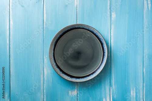 Plate on blue wooden background