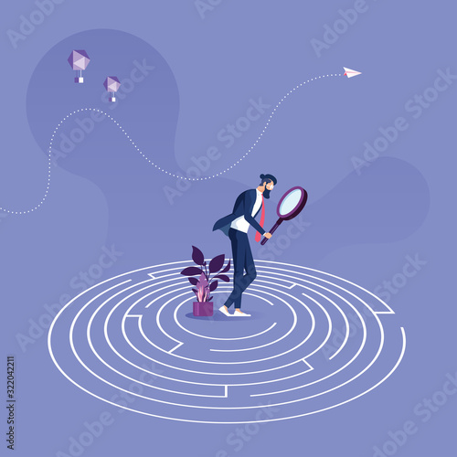 Businessman standing in the center of a maze trying to find way out-Business problem solution concept