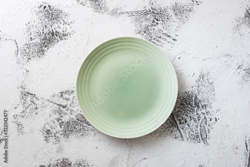 Green Plate on white scraped wooden background