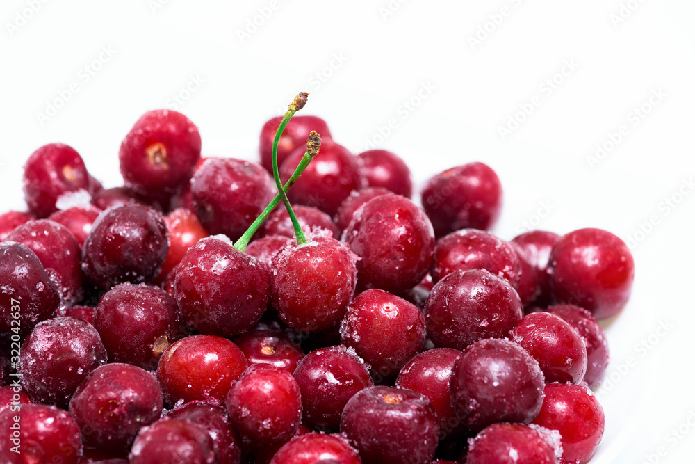 group of frozen cherries on a white background . close-up of berries. ice crystals on the fruit