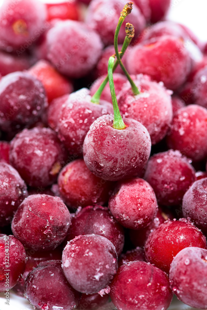 group of frozen cherries on a white background . close-up of berries. ice crystals on the fruit. vertical photo top view group of frozen cherries on a white background . close-up of berries. ice crystals on the fruit. vertical photo top view