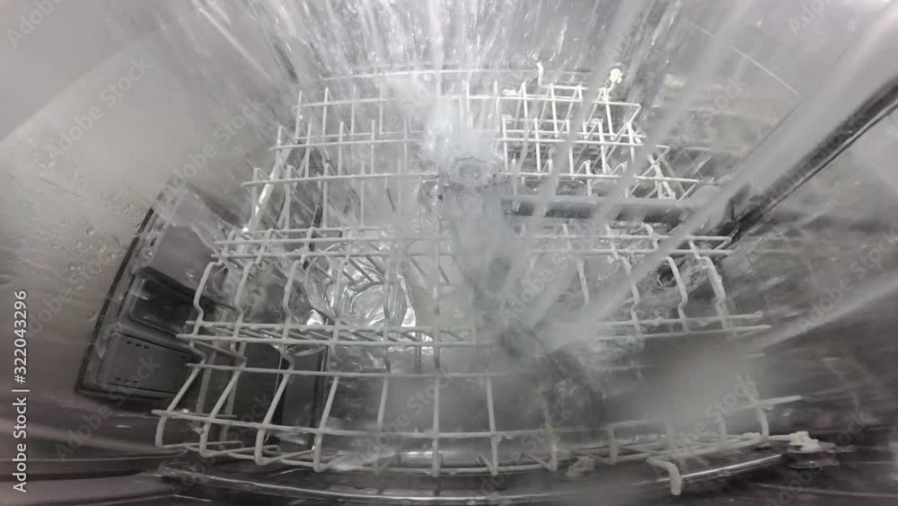 Slow motion. The master repairs the dishwasher and checks the operation