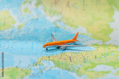 selective focus of toy plane on world map