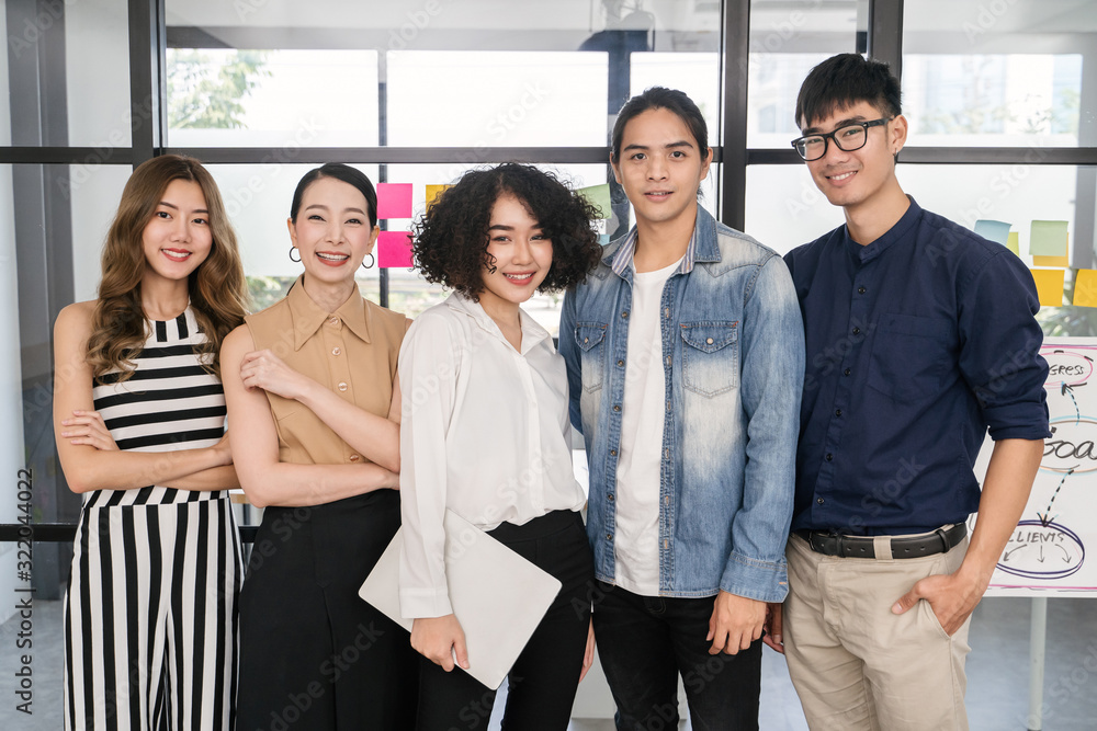 © saksit - Portrait of Asian creative business team. Hipster Creative Startup Young business people in modern office. © saksit - Portrait of Asian creative business team. Hipster Creative Startup Young business people in modern office.
