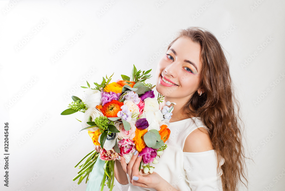 Young happy mother enjoying flowers bouquet in hands Young happy mother enjoying flowers bouquet in hands