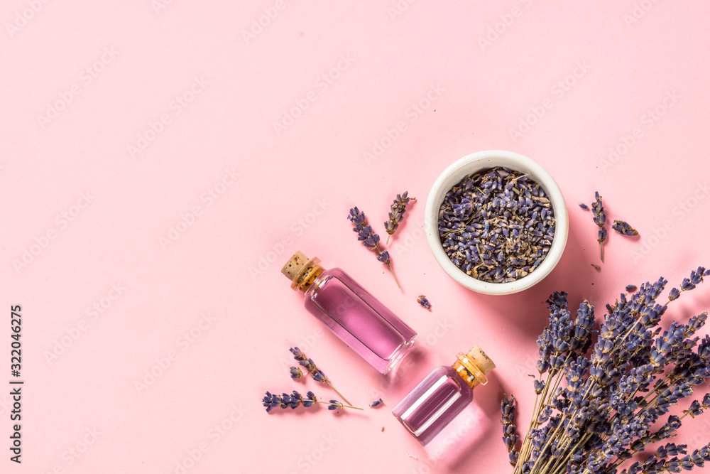 Fototapeta Lavender essential oil and perfume on pink.