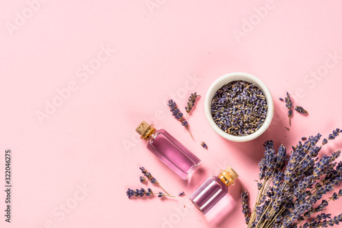 Photos Lavender essential oil and perfume on pink.