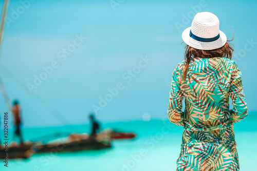 Young beautiful woman on tropical beach vacation