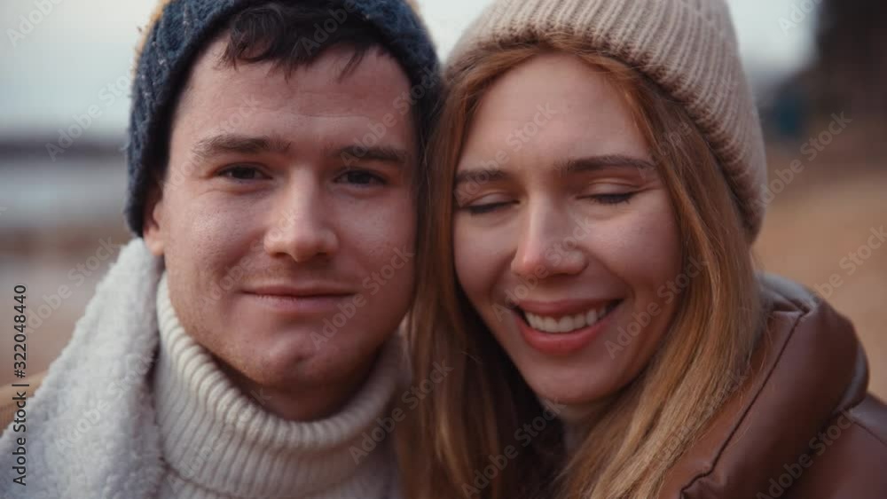 Close up portrait of Happy Family couple caress each other travel hiking love story in forest lake in USA, Alaska. Chocolate brown clothing. Close up portrait of Happy Family couple caress each other travel hiking love story in forest lake in USA, Alaska. Chocolate brown clothing.