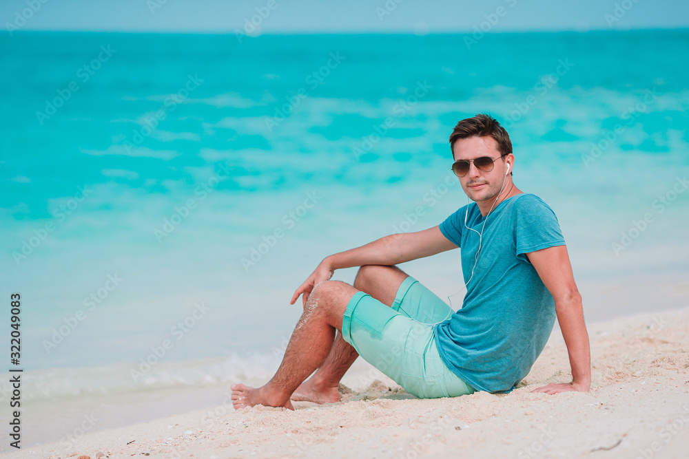 Young man on the white tropical beach Young man on the white tropical beach