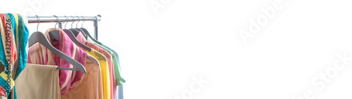 Spring fashion - pastel colored clothes on rail. Female colorful bright spring clothing set of on the racks on white background. Sale at clothing store concept. Banner.