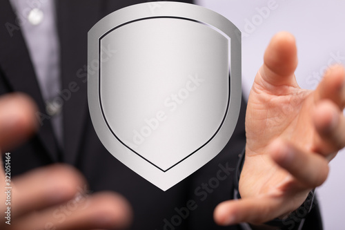 cyber shield protection concept holding in hand