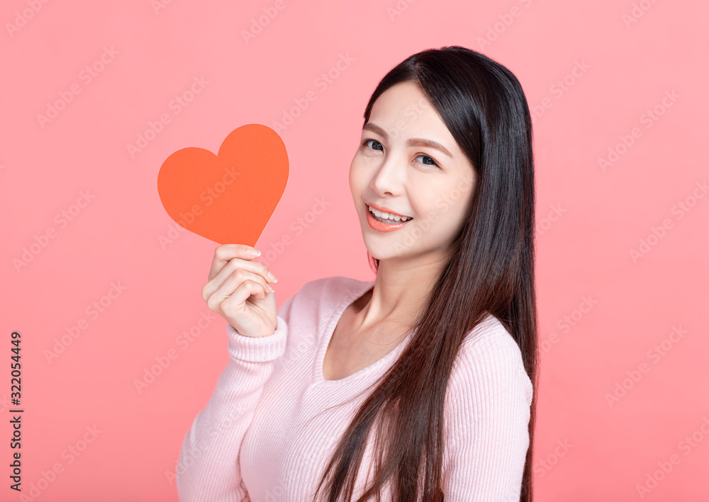 Happy young woman holding red paper hearts and celebrating valentines day Happy young woman holding red paper hearts and celebrating valentines day