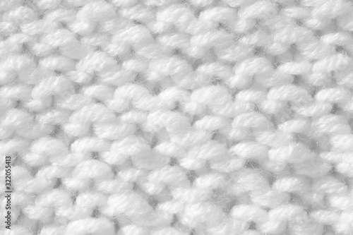 Handmade knitting texture  white background. Gray wool with fine threads  close-up.