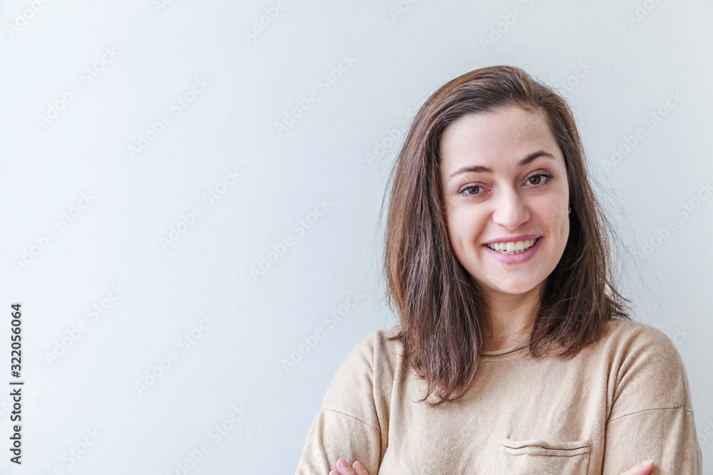 Happy girl smiling. Beauty portrait young happy positive laughing brunette woman on white background isolated. European woman. Positive human emotion facial expression body language Happy girl smiling. Beauty portrait young happy positive laughing brunette woman on white background isolated. European woman. Positive human emotion facial expression body language