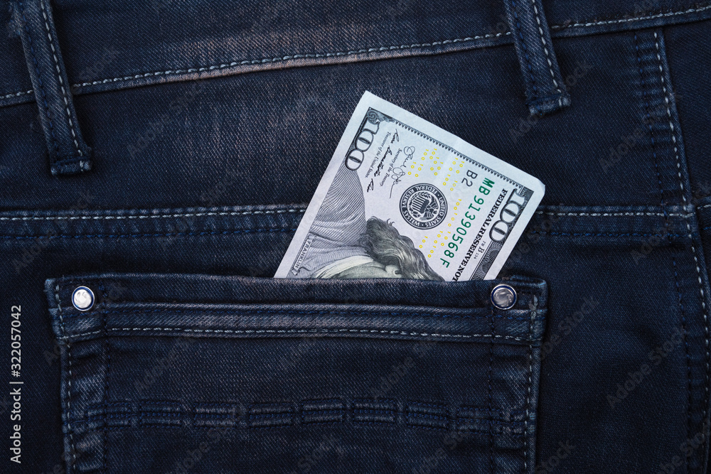 One hundred dollar banknote money in pocket jeans pants background texture. 100 dollar bill close up One hundred dollar banknote money in pocket jeans pants background texture. 100 dollar bill close up