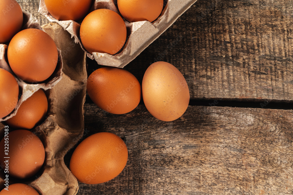 Chicken eggs in box on wooden table. Chicken eggs in box on wooden table.