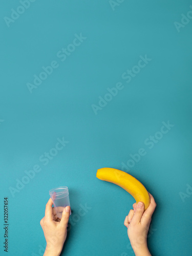 Women's hands hold a plastic container and a banana. Medical Testing Concept photo