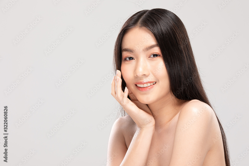 Beautiful Asian young woman touching soft cheek smile with clean and fresh skin Happiness and cheerful with positive emotional,isolated on white background,Beauty and Cosmetics Concept