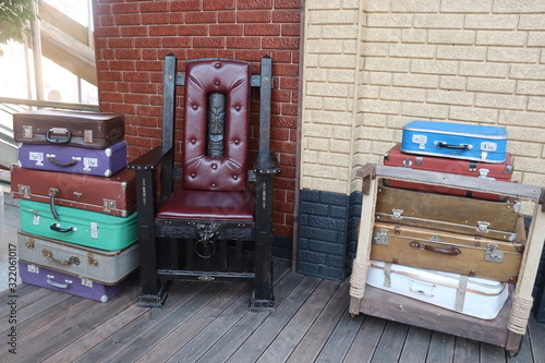 cozy chair from fairy tales with suitcases on floor
