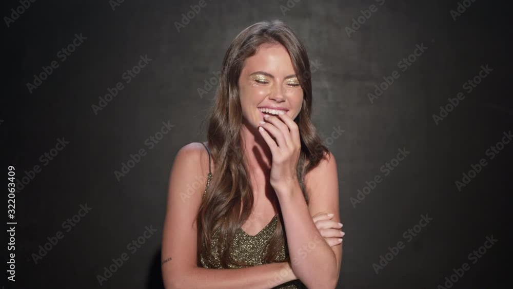 A happy young girl is laughing isolated over black background A happy young girl is laughing isolated over black background