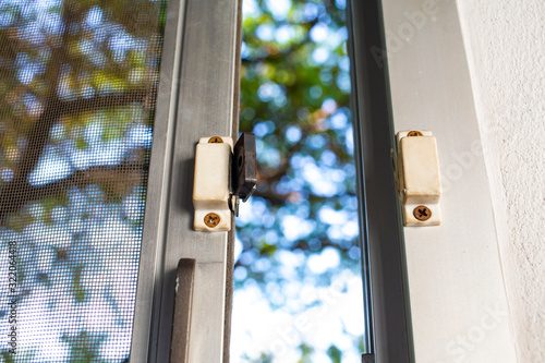 Broken security magnetic lock contact for mosquito wire screen window, Repair Room concept © eyepark