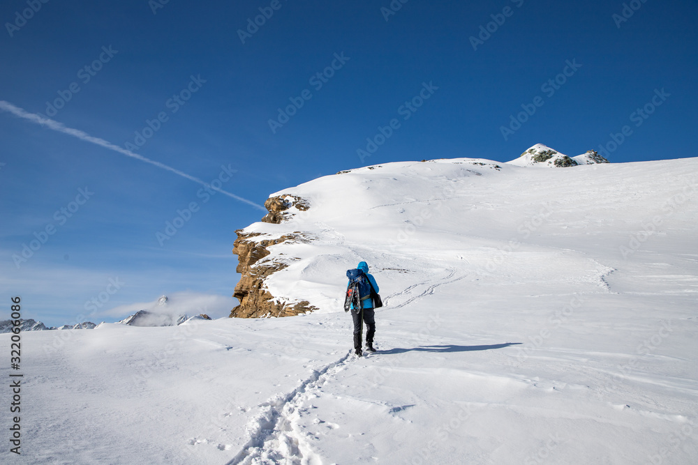 man trekking in snow in the Swiss Alps