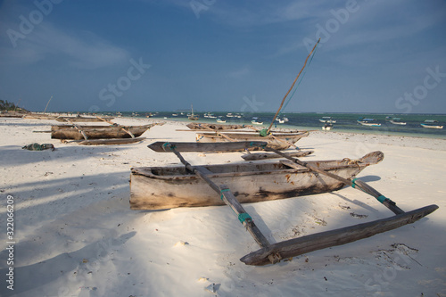 Wooden catamarans on sandy beach Zanzibar, Africa photo