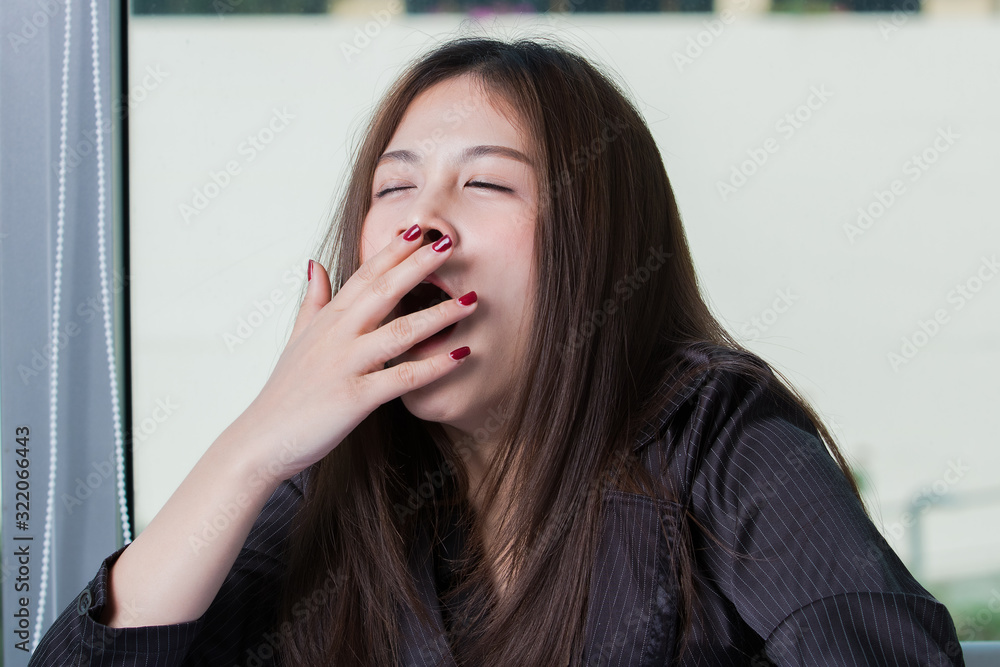 Asian female worker sleepy in the afternoon on a working day. Asian female worker sleepy in the afternoon on a working day.