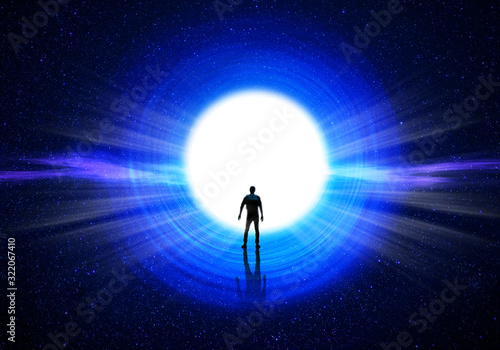 Fototapeta Man silhouette at the end of the tunnel with the universe and blinding light in