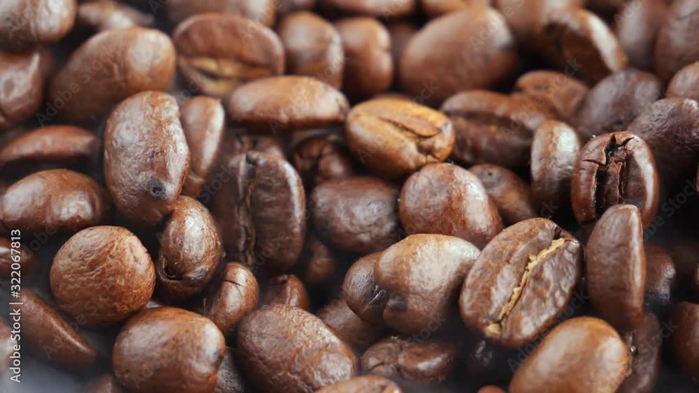 The coffee beans are roasted and mixed with a spoon. The coffee beans are roasted and mixed with a spoon.
