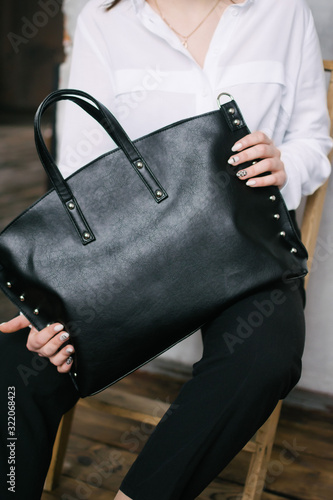 girl with a bag of leather in the interior