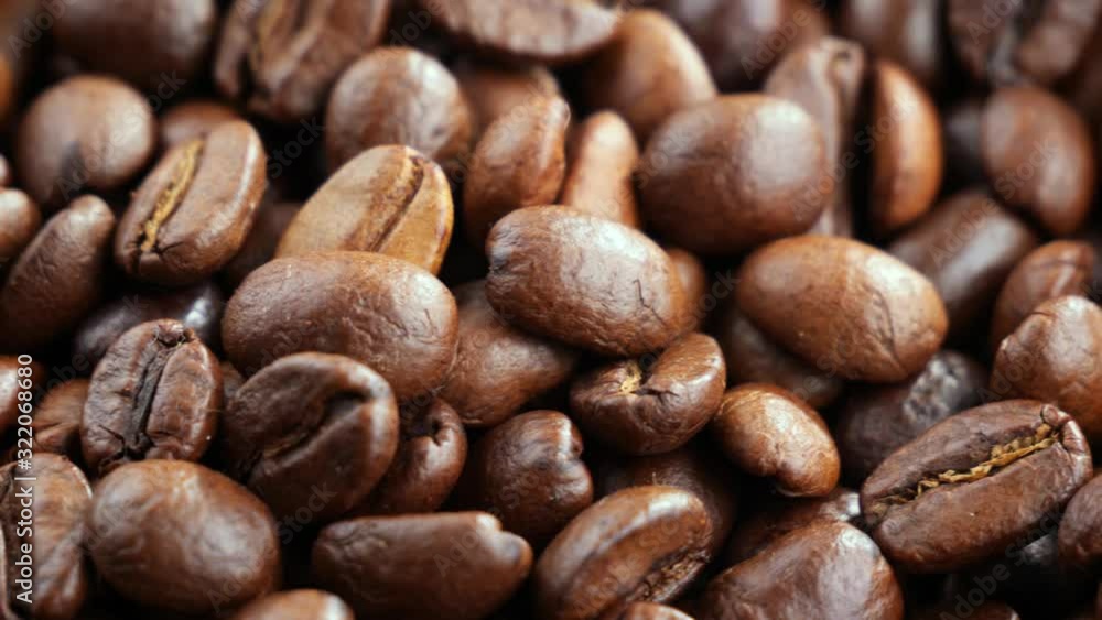 Black coffee beans roast in a pan in the smoke Black coffee beans roast in a pan in the smoke