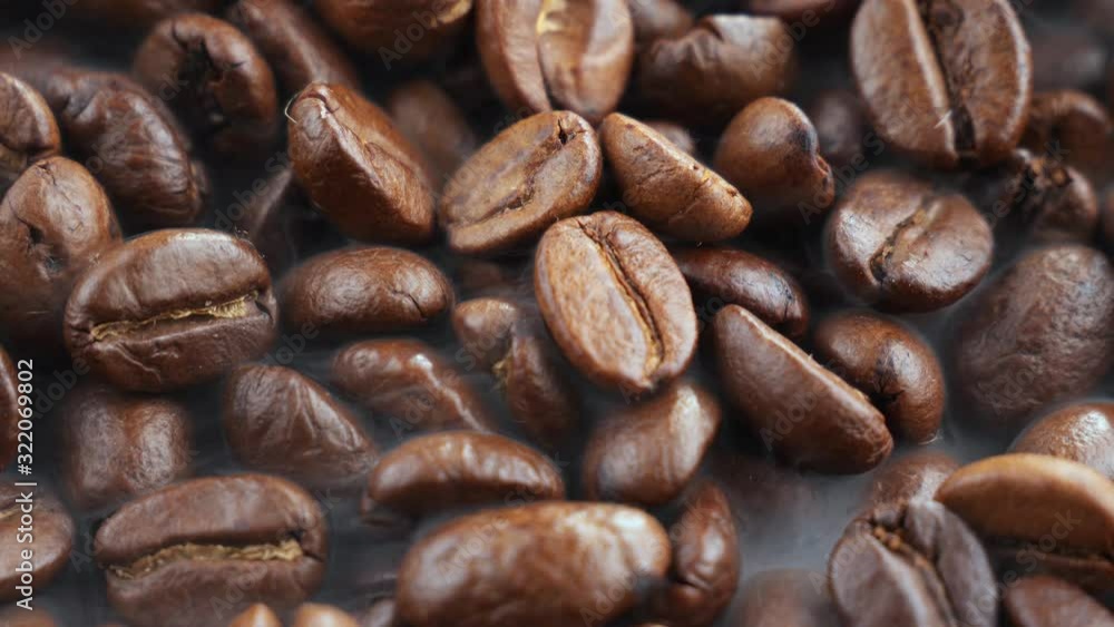 Black coffee beans roast in a pan in the smoke Black coffee beans roast in a pan in the smoke