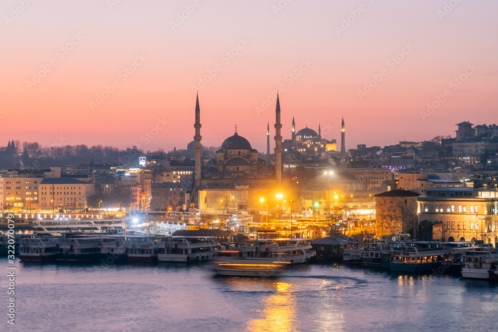 Istanbul, Turkey - Jan 14, 2020: New Mosque (Yeni Cami) at night with Hagia Sophia (Aya Sofya) behind seen across the Golden Horn, Istanbul, Turkey, Europe