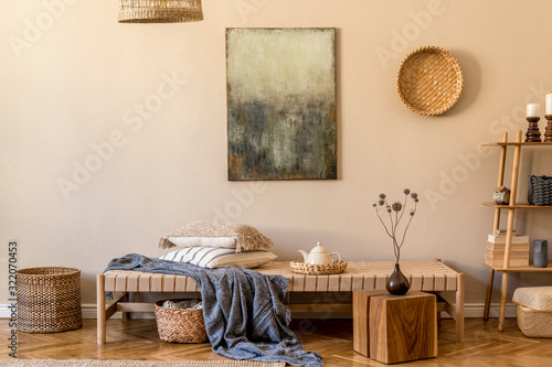 Fototapeta Naklejka Na Ścianę i Meble -  Modern composition of living room with design chaise longue, mock up paintings, rattan decoration, pillows, plaid, bamboo shelf and elegant personal accessories. Stylish korean concpet of home decor.