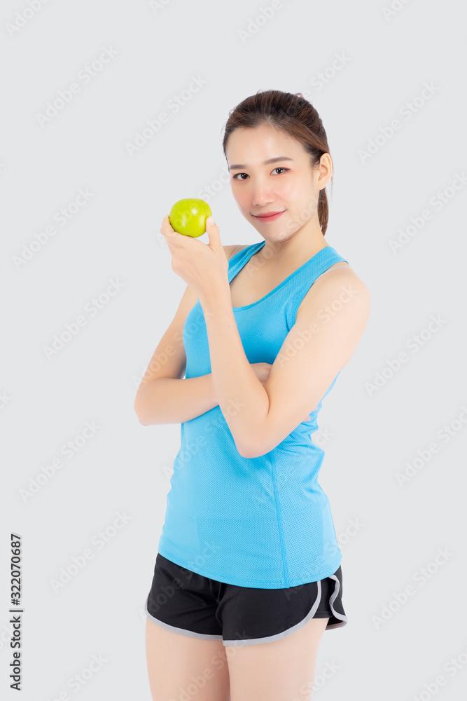 Beautiful portrait young asian woman in sport clothing with satisfied and holding green apple isolated on white background, girl asia have shape and wellness, exercise for fit with health concept. Beautiful portrait young asian woman in sport clothing with satisfied and holding green apple isolated on white background, girl asia have shape and wellness, exercise for fit with health concept.