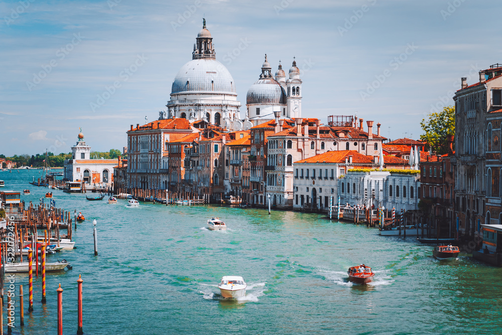 Grand Canal with tourist boats and Basilica Santa Maria della Salute in background, Venice, Italy
