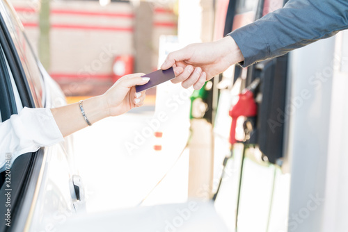 Attendant Receiving Credit Card From Woman