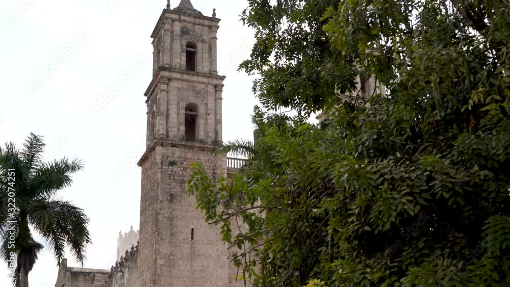 A reveal from behind a tree comes the towers of the Cathedral of San Gervasio in Valladolid, Yucatan, Mexico. A reveal from behind a tree comes the towers of the Cathedral of San Gervasio in Valladolid, Yucatan, Mexico.