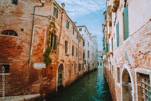 Venice, Italy. View of the Rio de Garzoni Canal and brick wall of ancient building